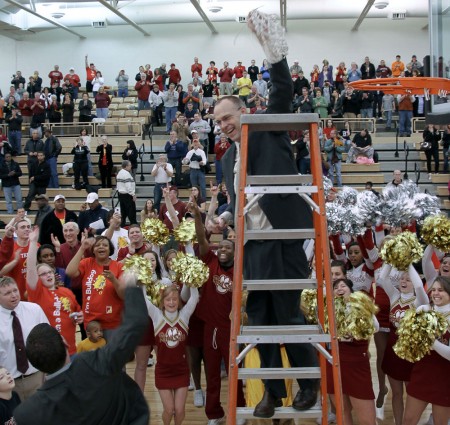 Cutting Down the Nets: Bulldog head coach Bill Sall holds the net after the team’s victory over Findlay on Feb. 19. in which the men’s basketball team claimed the GLIAC North title. Photo By: Brock Copus | Photographer