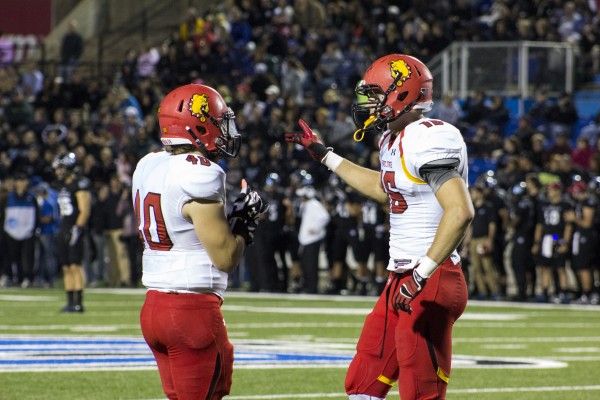 Sophomore linebacker KC Zenner and fellow linebacker Brady Sheldon talk over defensive schemes on the sideline.